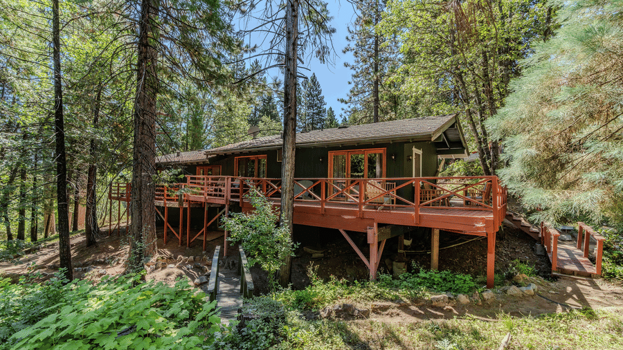 An exterior view of a cabin surrounded by greenery at Narrow Gauge Inn.