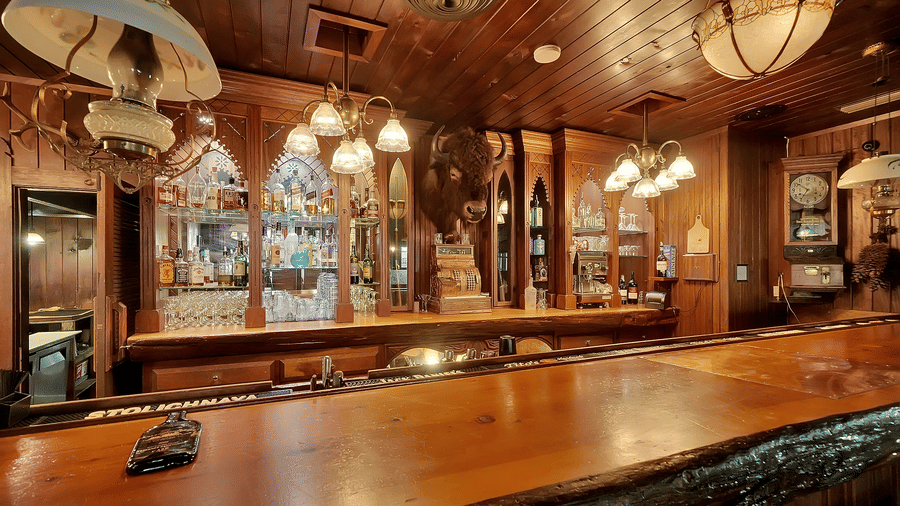 Bar area in one of the best restaurants near Yosemite Park, featuring wooden ceiling and warm lighting