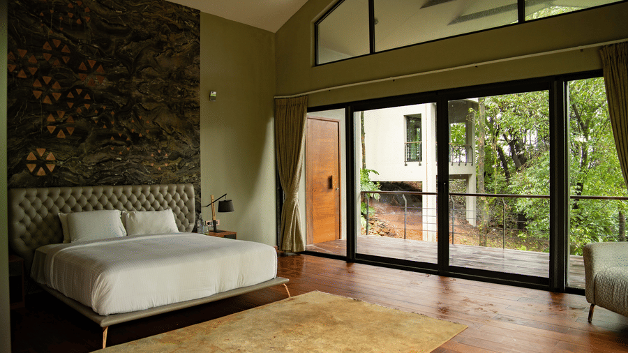 A room at Stanley Leisure with a double bed, wooden flooring and a balcony.