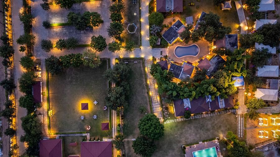 An aerial view of Valley by Grassfield, with pathways illuminated by lights and the accommodation surrounded by lush trees.