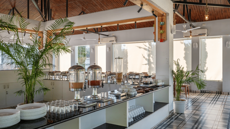 Buffet table with crockery in the dining hall at Valley by Grassfield, a resort in Jaipur.
