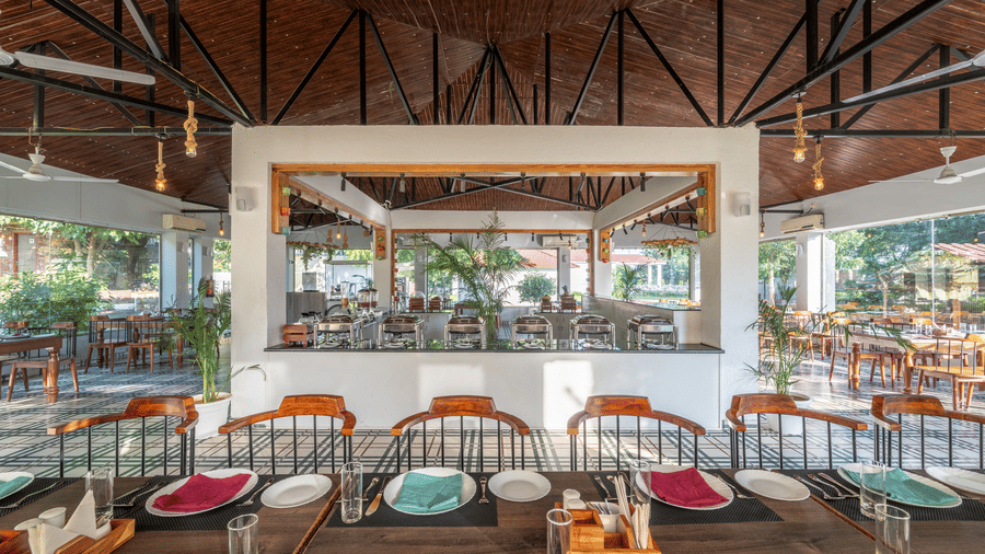Dining table set with cutlery and crockery at Valley by Grassfield, a resort in Jaipur.
