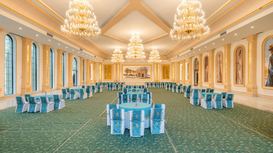 Round banquet tables in The Royal Knot hall at Valley by Grassfield, a venue for destination weddings in Jaipur.