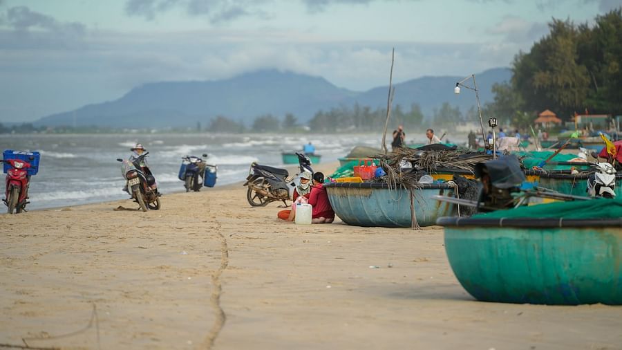 Fishing boats docked on the beach on a cloudy day