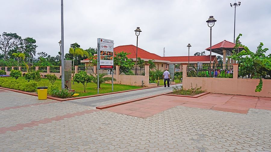 Entrance view of Vithal Kamat restaurant showing wide paved area and landscaped surroundings
