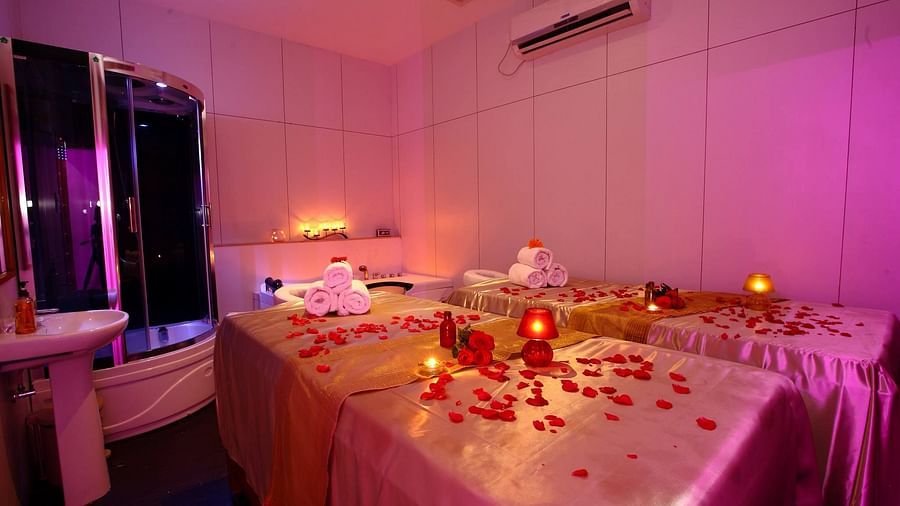 the massage bed at the spa in Chennai with rose petals kept on it at Raj Park Hotel, Chennai