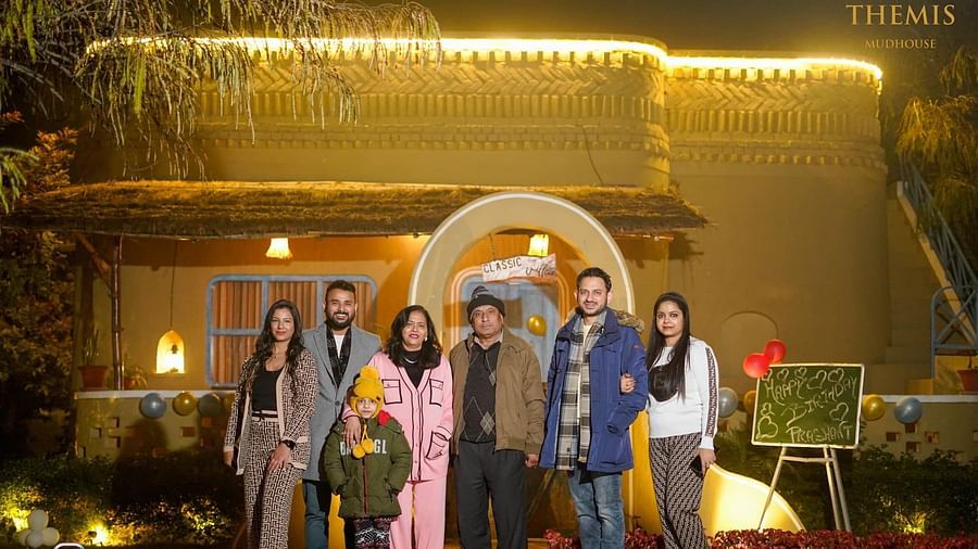 A group of people standing in front of Themis Mudhouse - A Nature's Retreat Resort & Wellness's entrance