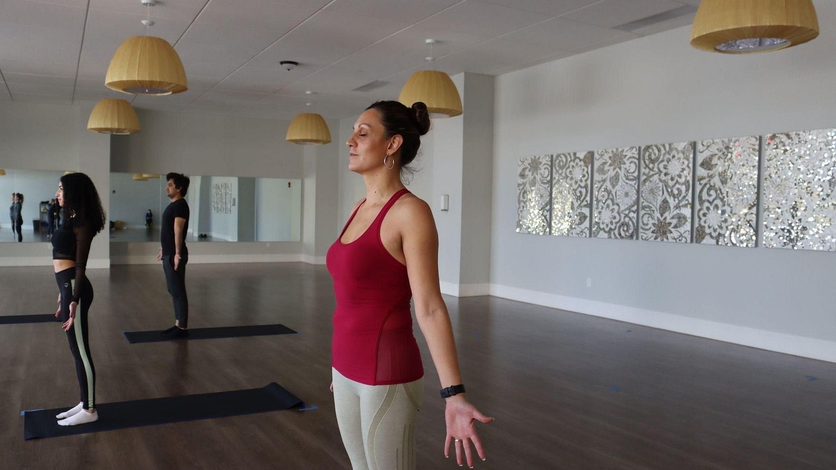 Group of people practicing yoga in a yoga studio at YO1 Health Resort, Catskills, New York.