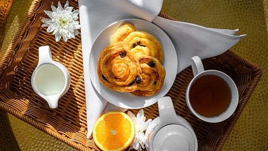top view image of the breakfast featuring pancakes and a slice of orange - Maikhao Dream Villa Resort & Spa, Phuket