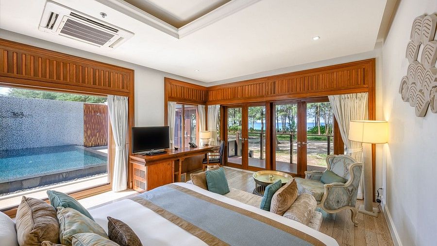 image of a bedroom with the views of the swimming pool and beach views - two bedroom private pool beachfront villa