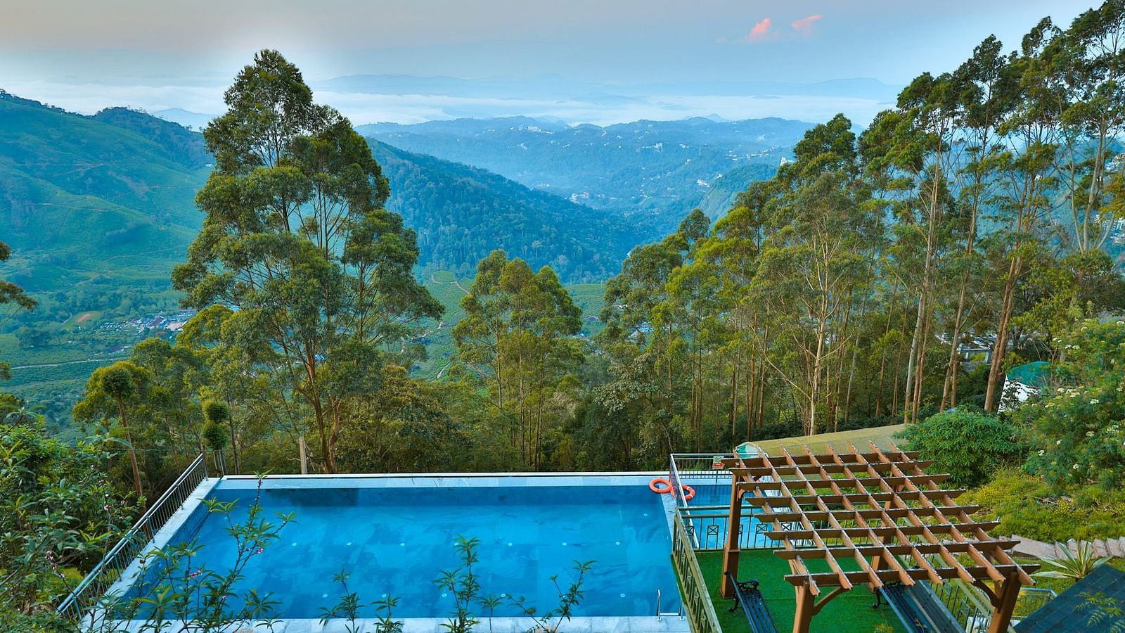 Image featuring landscape view of greenery and mountains from an aerial view of the swimming pool