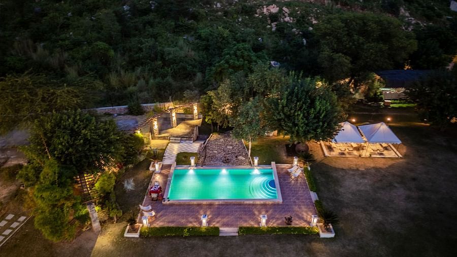 Aerial view of a swimming pool illuminated with lights at Valley by Grassfield.