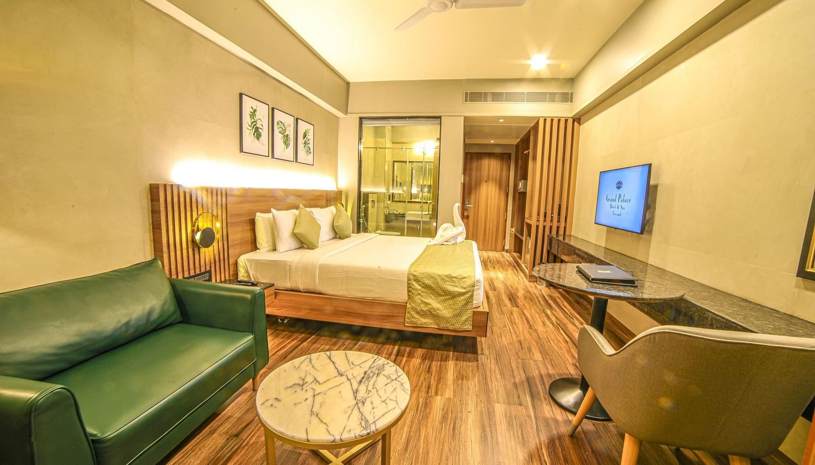 Side view of the bed and the sofa in the Sunrise Room at Grand Palace, Yercaud
