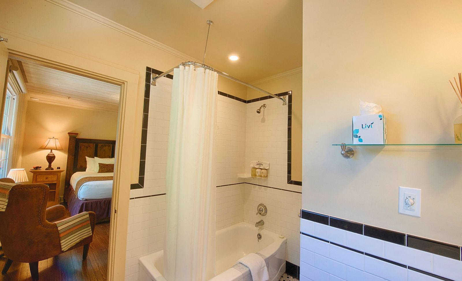 a door opening into the bathroom with a full size bath tub beside it - Historic Tapoco Lodge