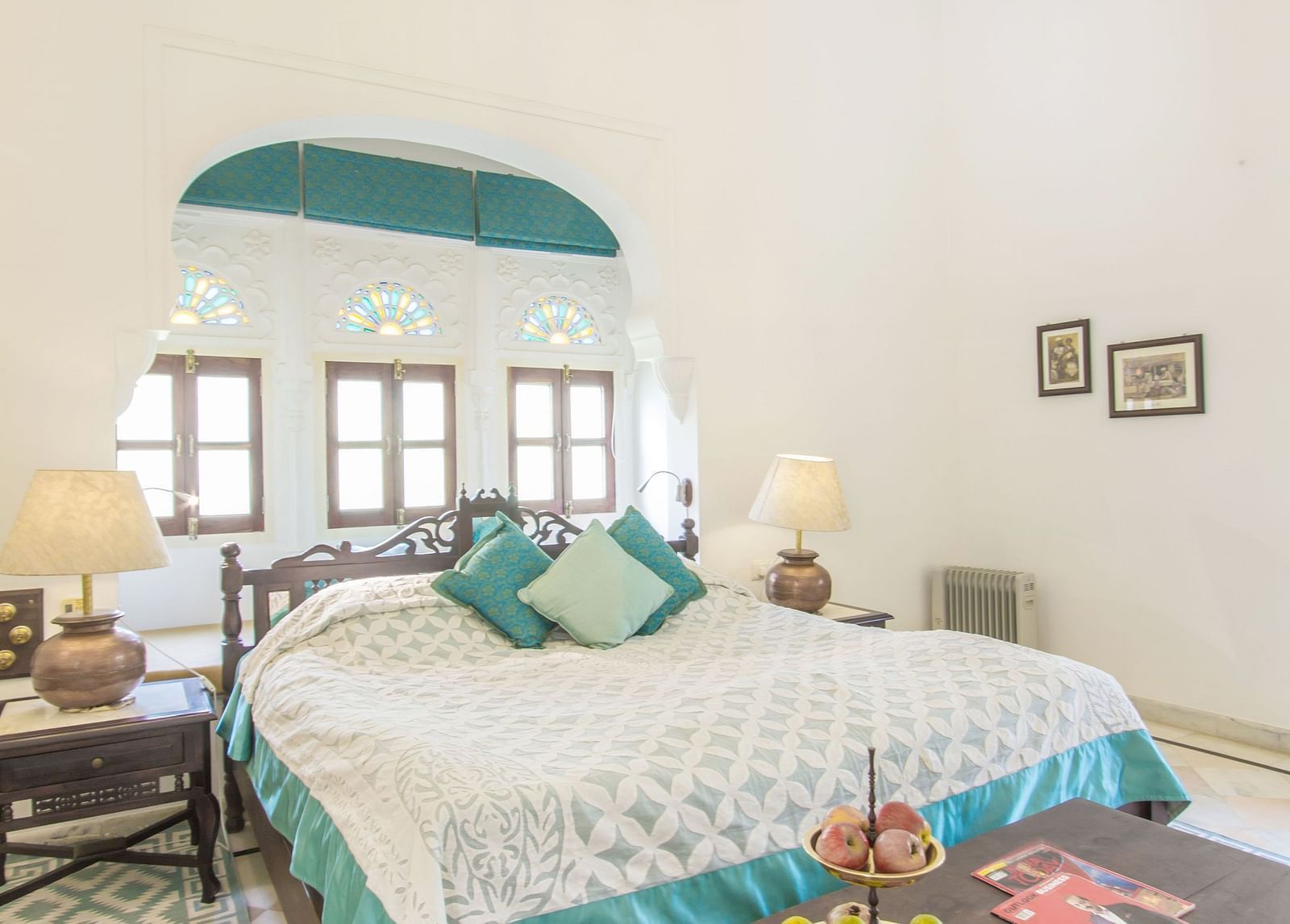 image of a bedroom with a double bed with white coloured walls at dev shree, deogarh