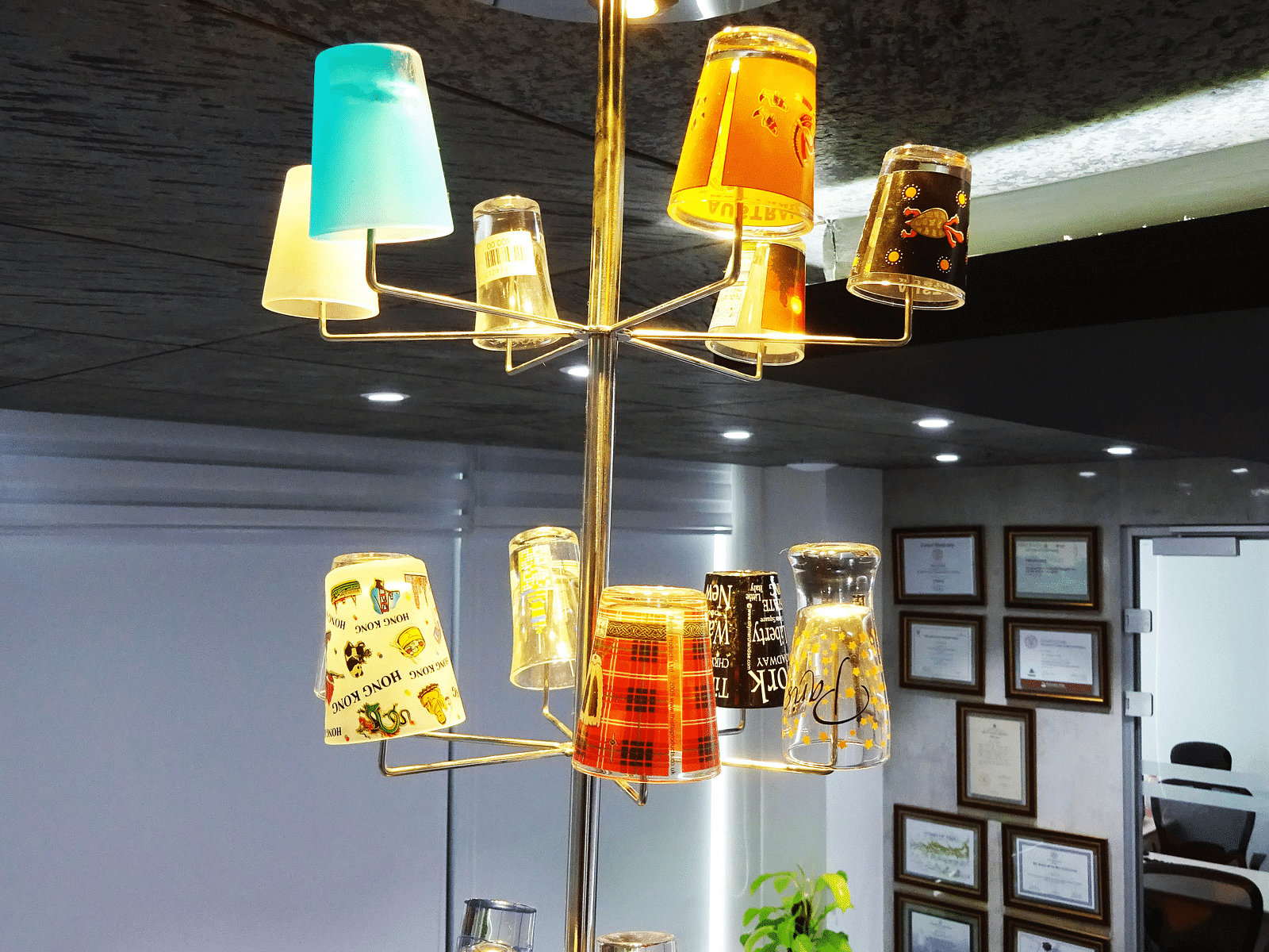 View of a unique chandelier made with different colourful glasses.