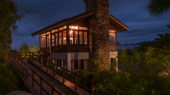 The exterior view of The Serai Resort Bandipur lit up at night