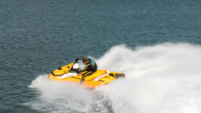 A person riding a jet ski on a clear, blue day