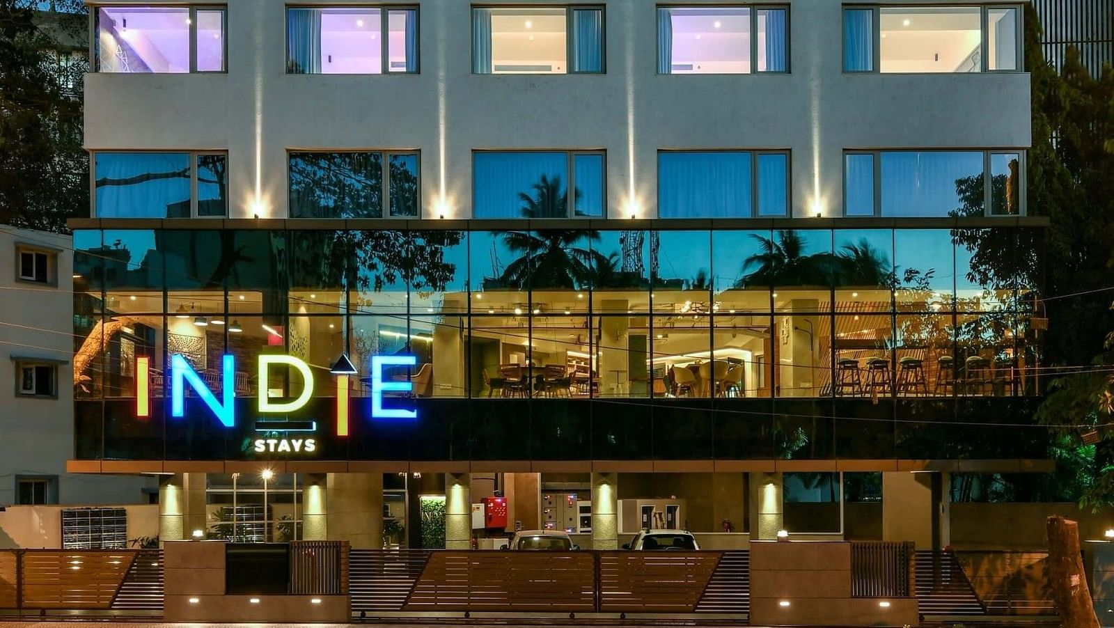 A close-up facade view of Indie Stays, BKC Kalina, illuminated against the night sky.