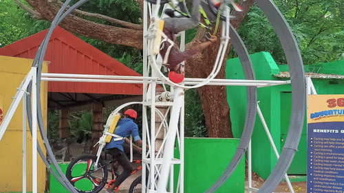 A person riding a bicycle going in a circular motion at Black Thunder, Coimbatore
