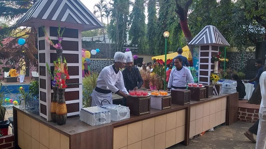 the outside area at the lawn with chefs preparing food for an event - Zara's Resort