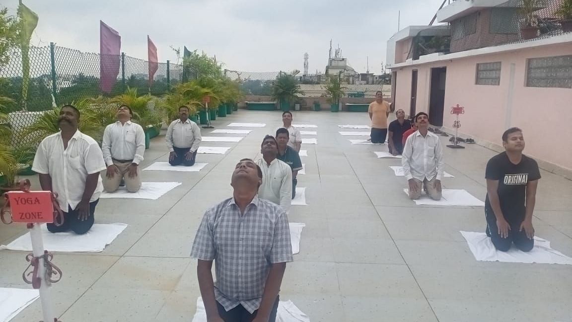 People practising yoga at Swosti Resorts on an overcast day