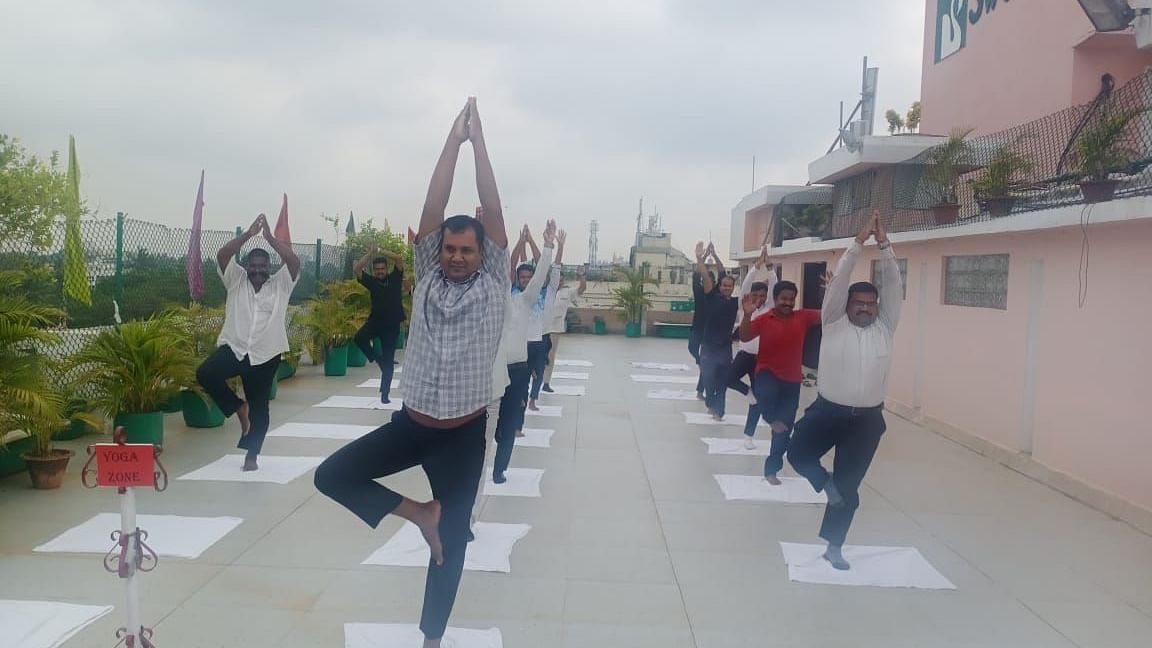 People practising yoga at Swosti Resorts on an overcast day
