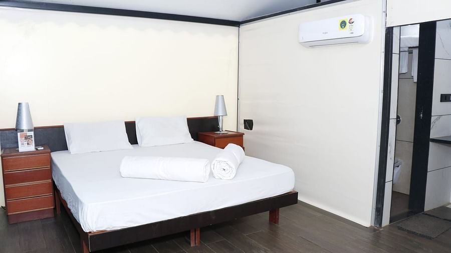 an image of a premium tent room with a king size bed and multiple pillows at an image of a tent room with an air-conditioner at VITS Roccia Hill Resort & Adventure Park.