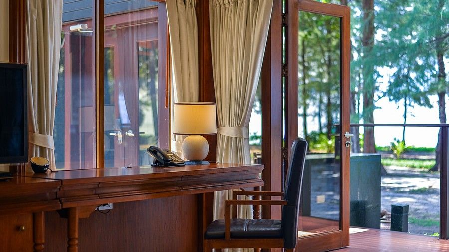 image of a work desk with open french windows - two bedroom private pool beachfront villa
