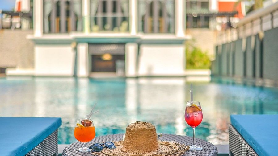 a close up image of two glasses of refreshing beverages placed on the table with a straw hat - Maikhao Dream Villa Resort & Spa, Phuket