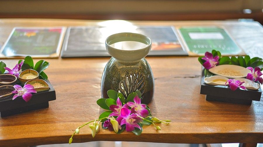 image of a oil diffuser lamp with flower petals in front of it - Maikhao Dream Villa Resort & Spa, Phuket