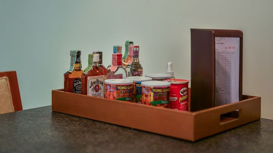 image of an assortment of alcoholic beverages along with packaged snacks on a tray - Maikhao Dream Villa Resort & Spa, Phuket