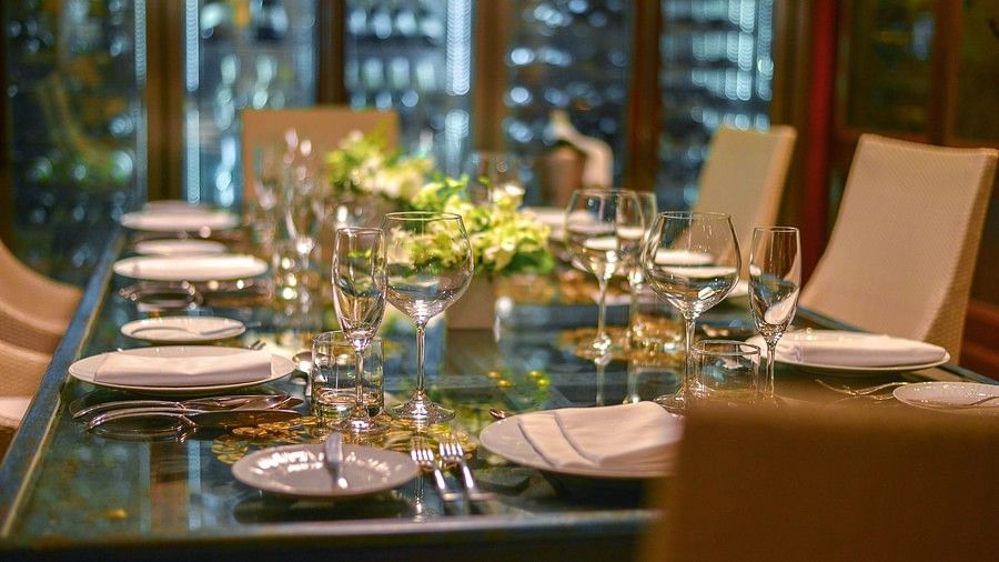 a close up image of the dining table with well arranged crockery and glassware - Maikhao Dream Villa Resort & Spa, Phuket
