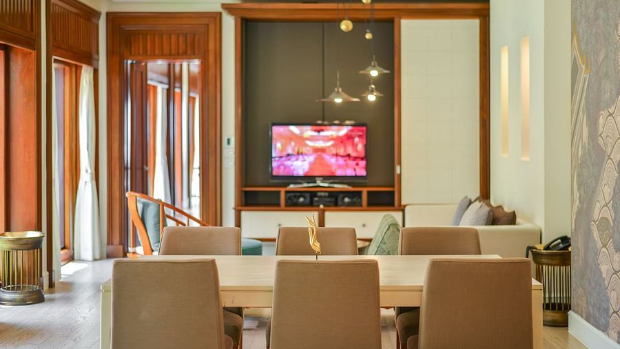 image showcasing a switched on television and a dining area - one bedroom private pool beachfront villa