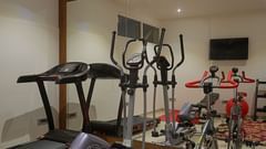 A image of our fitness centre with equipment placed in front of a mirror - Grand Continent, Malleshwaram