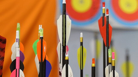 Close-up of colourful arrows in a quiver, ready for archery at Nirantara Resort & Spa.