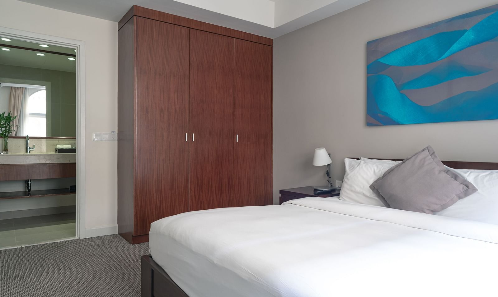 A bedroom with a large bed and a closet | Two-bedroom Suite | Central Mansions, Phnom Penh