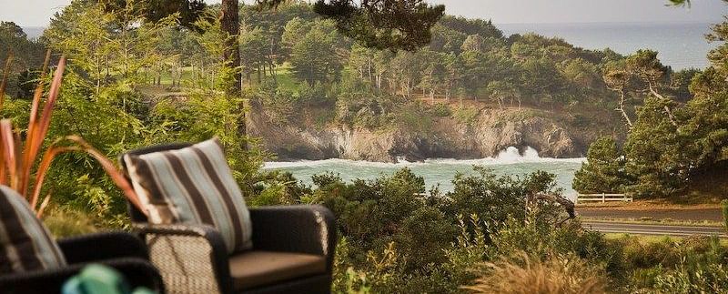 A view of the waves crashing against the shore seen the wooden deck at Brewery Gulch Inn & Spa