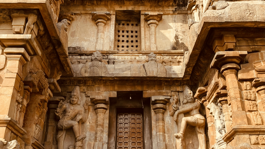 A stone staircase leading up to the entrance of a temple in India.