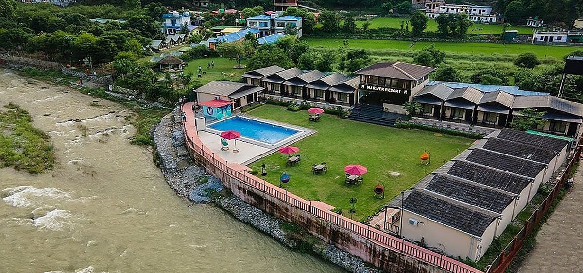 Aerial view of DLS MJ River Resort, Rishikesh during the day.