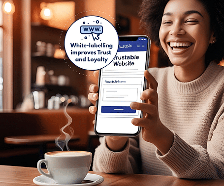 A smiling woman with Afro-textured hair holds a phone displaying a website, with a graphic highlighting how white-labelling improves trust and loyalty.