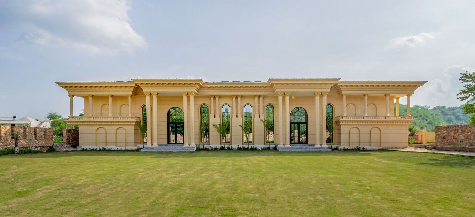 Facade of The Royal Know Banquet Hall at Valley by Grassfield, featuring large windows and a spacious open area in front.
