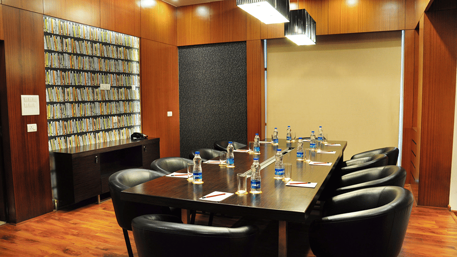 The Alpha Boardroom at The Senses Hotel with wooden interiors and modern white lighting hanging from the ceiling.
