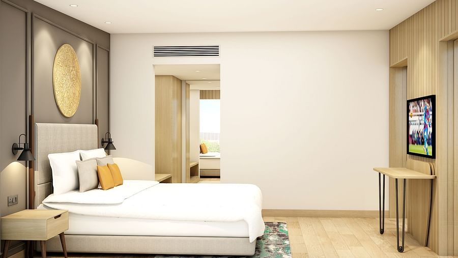 Suite room with pristine white bedsheets and a TV -  Sarovar Portico Srinagar