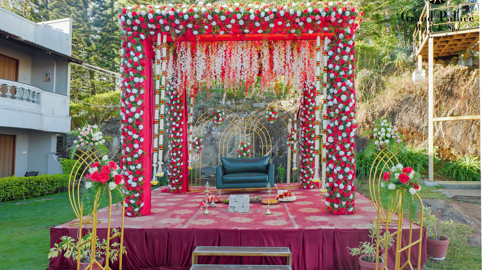 Outdoor wedding stage at Grand Palace, Yercaud with floral backdrop, chairs, steps, walkway, floral decorations, and garden area ready for ceremony.