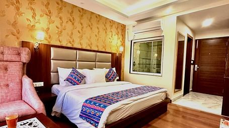 full view image of the superior room featuring a double bed and the entrance of the room - ZENQ SIGNATURE INN, MCLEODGANJ