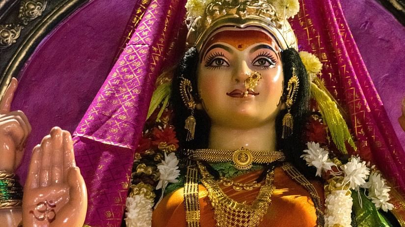 A statue of a woman in a colourful outfit