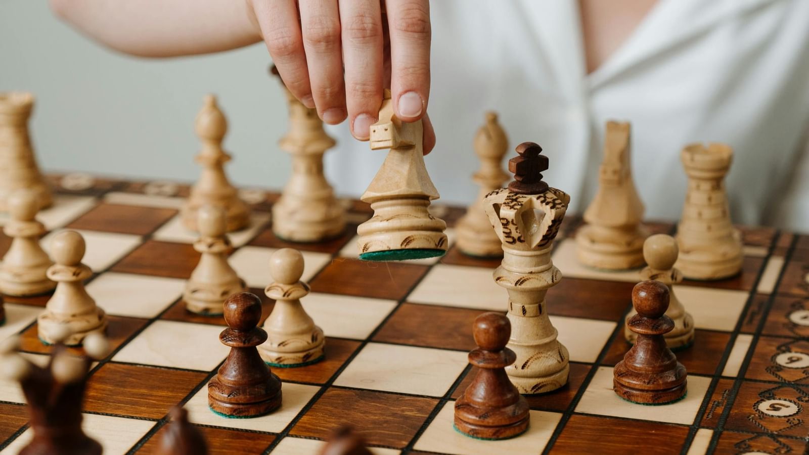 A woman playing chess with a chess board and coins