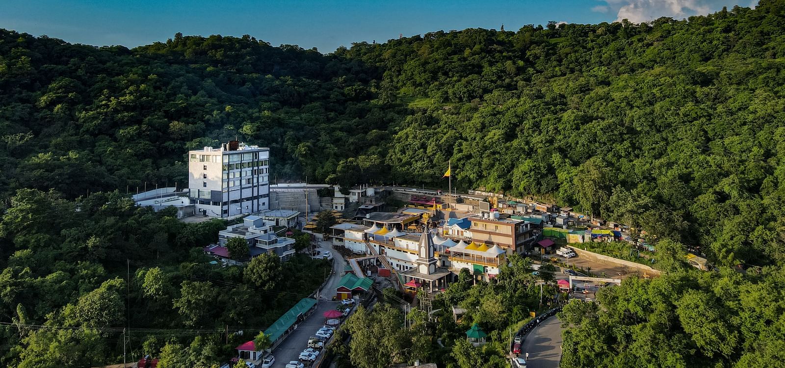 An image of NAMAMI BY ZENQ BANKHANDI covered by lush green mountains of  of the Dhauladhar range - NAMAMI BY ZENQ BANKHANDI