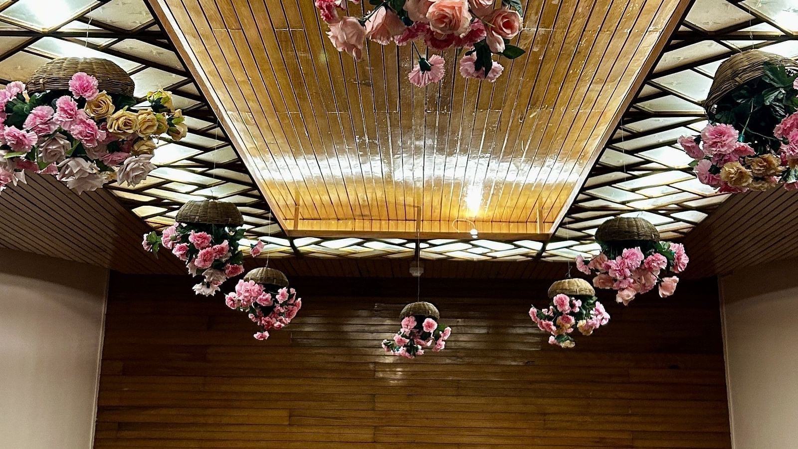 Indoor wedding setup at Cedar Inn, Darjeeling, featuring a decorated ceiling canopy and cosy seating area.